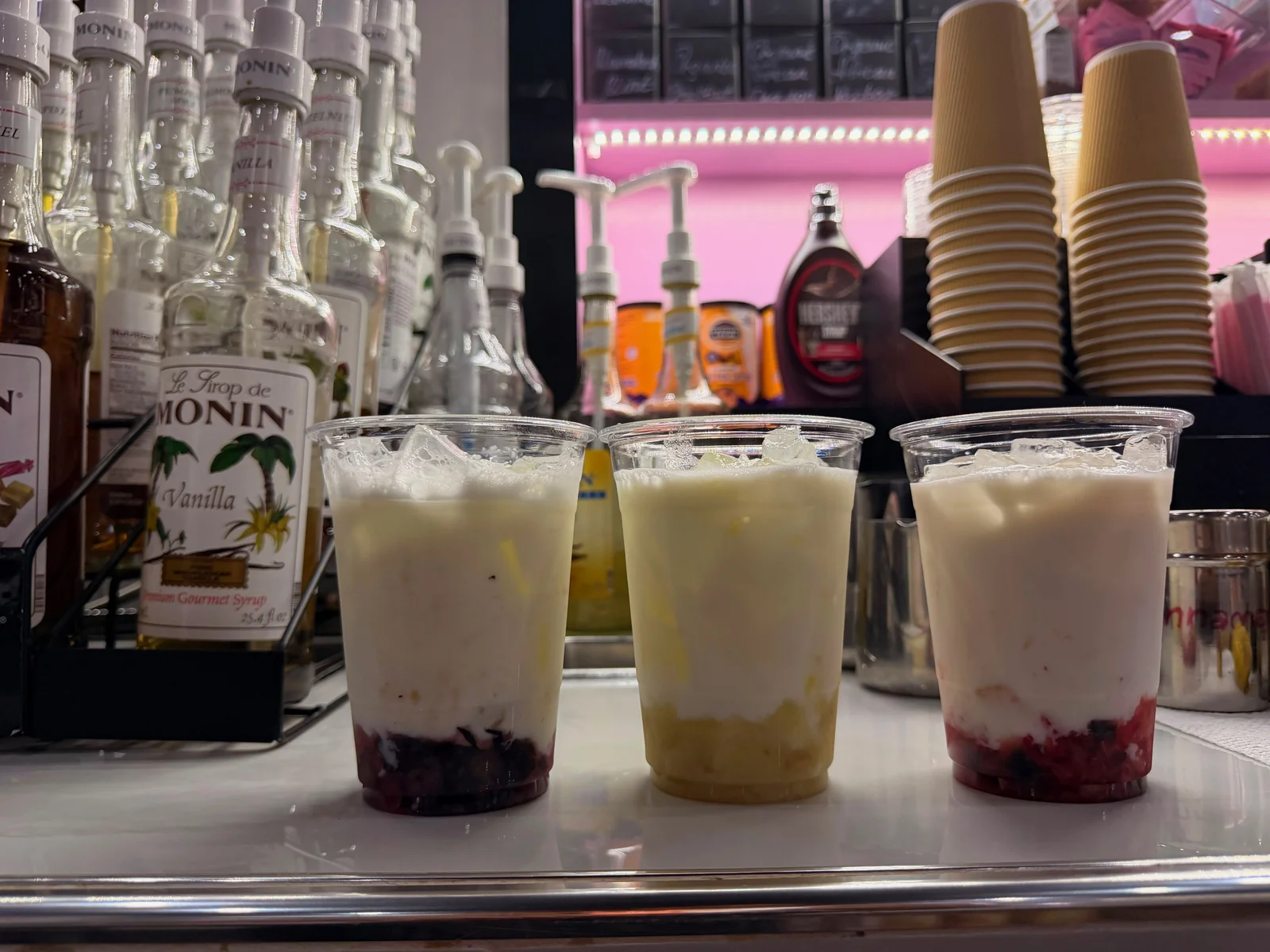 Cold oat milk layered over fresh fruit and ice